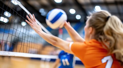 A skilled female volleyball player in an orange jersey is captured mid-action, making a defensive block at the net during a competitive game.