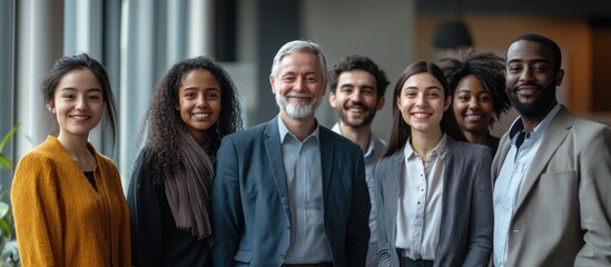 Obraz premium Diverse group of smiling business people standing together in a row.