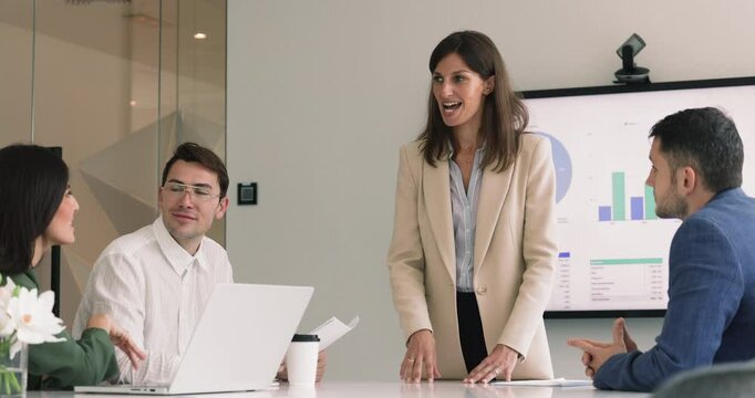 Business woman lead corporate meeting, make speech, provide explanations about new project or goals, share sales revenue, marketing strategy met in company office. Briefing, negotiation, seminar event
