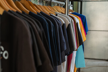 A row of t shirts hanging on hangers