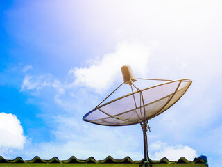 Satellite dish mounted on the roof with sky clouds. Satellite dish, image transmission and communication system. Telecommunication system, Internet, communicate satellite, network signal multimedia