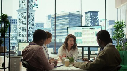 General director sharing insight about a new expansion strategy with her employees, presenting data reports to analyze business activity status. Coworkers in a briefing meeting. Camera B.