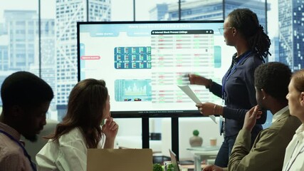 Employees team analyzing infographics to offer solutions for new project, looking to finish tasks before deadline. Enterprise coworkers attending problem solving conference in boardroom. Camera A.