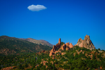 Garden of the Gods in Colorado Springs, Colorado, United States: A tranquil early autumn landscape of the National Natural Landmark with white cloud in the clear blue sky