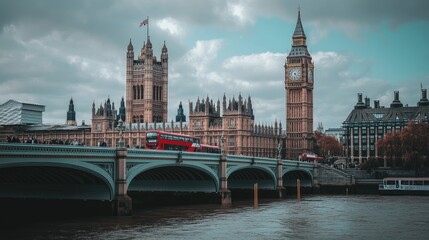 Fototapeta premium A picturesque scene of Big Ben and the Houses of Parliament in London, with the River Thames flowing calmly and iconic red double-decker buses crossing the bridge.
