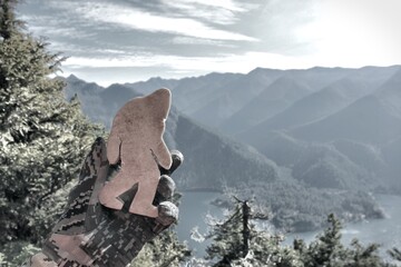 Stone Bigfoot looking out over mountain area scenery from above