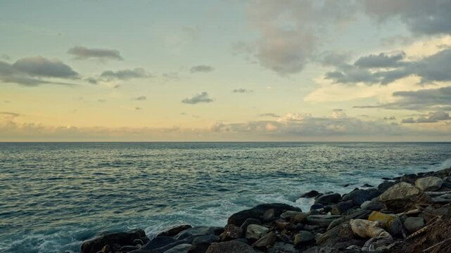 Slow motion of waves breaking on the rocks on a tropical beach at sunset. Macuto Coast, Venezuela.
