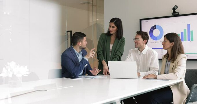 Team using laptop discuss financial data, planning joint project or upcoming quarter, reviewing budget allocations, analyzing performance metric, and brainstorming strategy to improve future results