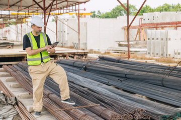 Fototapeta premium Engineer worker, Officer working check steel bar strength grade for high quality products and standard in construction site.