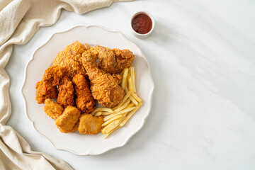 fried chicken with french fries and nuggets on plate