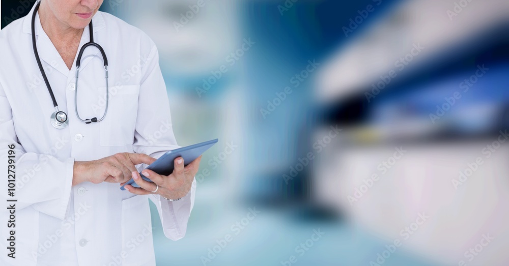 Sticker Mid section of caucasian female doctor using digital tablet against blur background with copy space