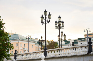 Beautiful white marble balusters and lamp posts on Manezhnaya Square in Moscow. Cityscape.