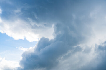 bright blue sky with scattered, white fluffy clouds.