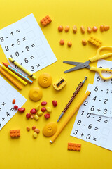 Materials for teaching children to count. Back to school concept. Yellow school supplies.	 