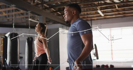 Animation of data processing over diverse man and woman exercising in boxing gym - Powered by Adobe