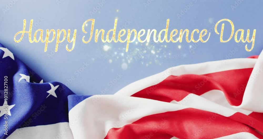 Wall mural Animation of happy independence day text in sparkling gold over flag of america and blue sky