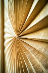A close-up view of a pleated, beige fabric curtain with a fine, woven texture