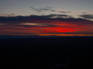 Unreal colors of the sunset sky. Formation of clouds paint the sky red at sunset. Evening view twilight Sky on Sunset. The beauty of the nature of Ukraine. Heavenly picture. 