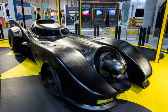 Front view of the iconic and sleek black Batmobile movie car replica on display at an indoor exhibition event.