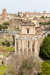 Rome, Italy - April 09, 2024: Ruins of the Roman Forum with tourists strolling among the archaeological remains in Rome, Italy