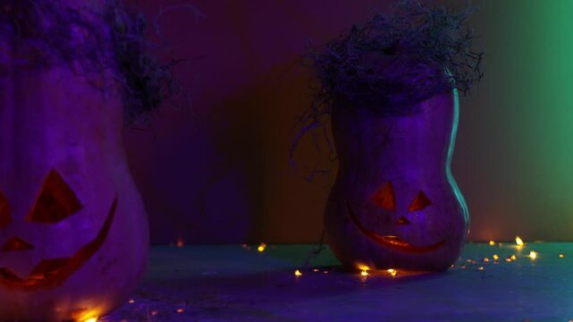 Halloween celebration. Background in purple color with pumpkin and shadow from branches. 