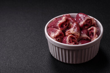 Raw chicken hearts with salt, spices and herbs