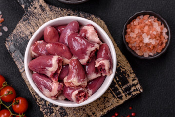 Raw chicken hearts with salt, spices and herbs