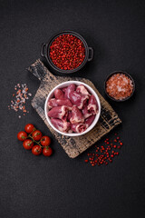 Raw chicken hearts with salt, spices and herbs