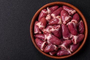 Raw chicken hearts with salt, spices and herbs