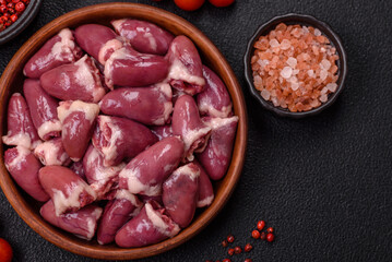 Raw chicken hearts with salt, spices and herbs
