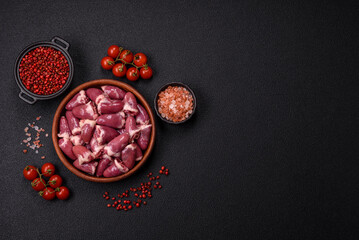 Raw chicken hearts with salt, spices and herbs