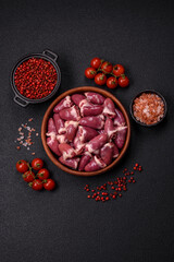 Raw chicken hearts with salt, spices and herbs