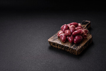 Raw chicken hearts with salt, spices and herbs