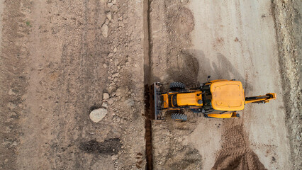 small construction equipment digging ditch