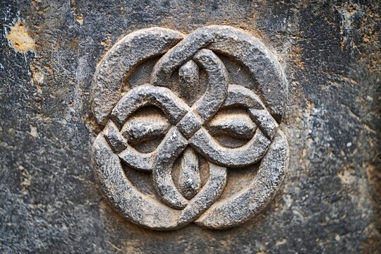 An elaborate emblem of wisdom carved into timeless stone embodies the intersection of art and history in a stunning image.