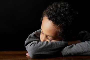 Fototapeta premium boy in poverty being bullied at school with depression no help crying alone and all by himself on grey background with people stock photo stock image