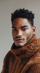 A man with a beard and a brown sweater