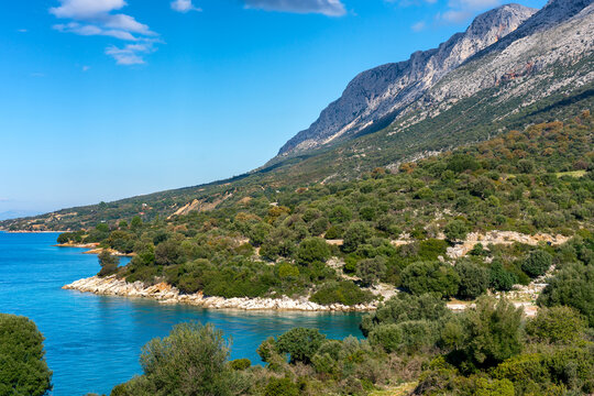 Coastal landscape of wild beaches, trees and mountains in Greece