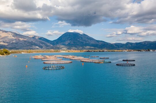 Floating circular fish farms drone view on the sea of Greece