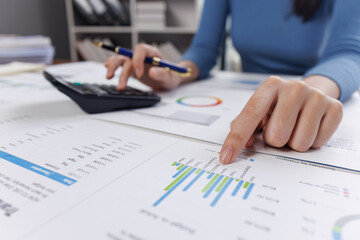 Business financing accounting banking concept. Business woman hand doing finances and calculate on desk about cost at home office. Woman working on desk with using calculator, finance accounting.
