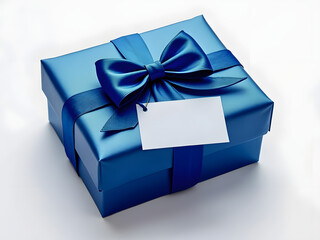 A beautifully wrapped blue gift box with a satin ribbon and tag ready for a special occasion or celebration