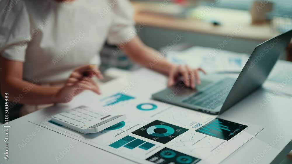 Poster Businesswoman working on financial data while using a calculator and laptop. Analyzing charts and graphs, she focuses on accounting and strategic planning in a corporate environment