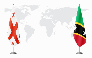 Georgia and Saint Kitts and Nevis flags for official meeting against background of world map.