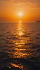 Fototapeta premium A peaceful sunset over the sea with warm golden hues reflecting on the water, creating a tranquil atmosphere perfect for relaxation and beachside retreats.