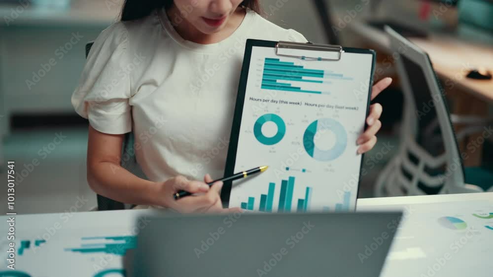 Poster Businesswoman engaging in a video conference while presenting charts on a laptop. Utilizing technology for effective communication and collaboration in a remote work setting