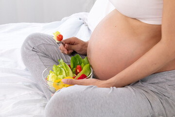 Pregnant healthcare nutrition concept, young Asian pregnancy woman enjoy eating salad for breakfast, maternity female food healthcare motherhood lifestyle, healthy well-being comfort nurturing