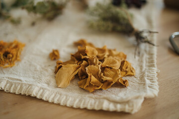 Macro photo of dried yellow rose leaves on a linen tablecloth