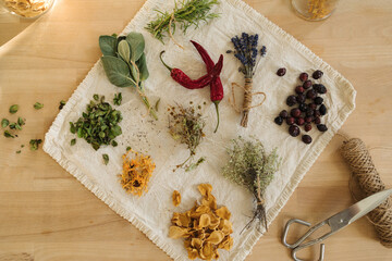 Top view of dried herbs and seasonings on linen tablecloth. Healthy homemade and natural.