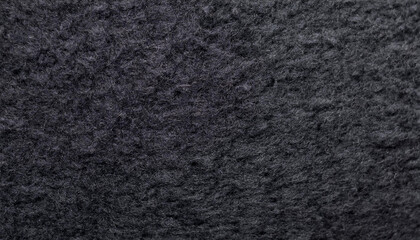 Fototapeta premium Black felt material. Surface of felted fabric texture abstract background in dark gray color.