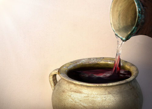 A hand holds a clay jar and pours water